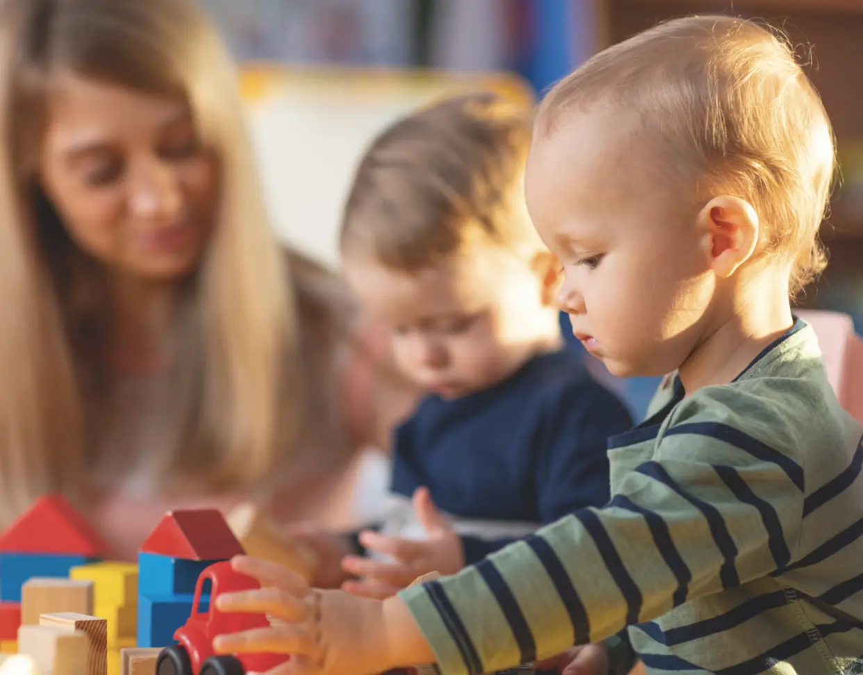 2 baby playing with toy